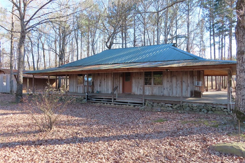 99 Lafayette 215 Road Taylor, AR 71861 - Photo 1 of 18 a backyard of a house with barbeque oven table and chairs