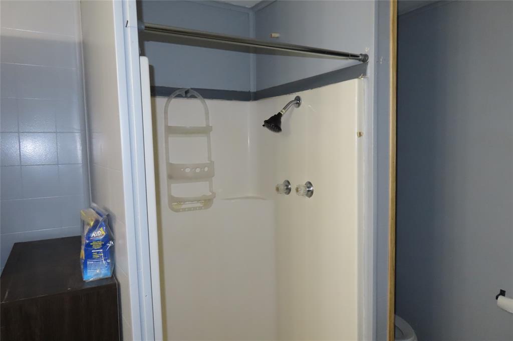 99 Lafayette 215 Road Taylor, AR 71861 - Photo 11 of 18 a bathroom with a glass shower door and a bathtub