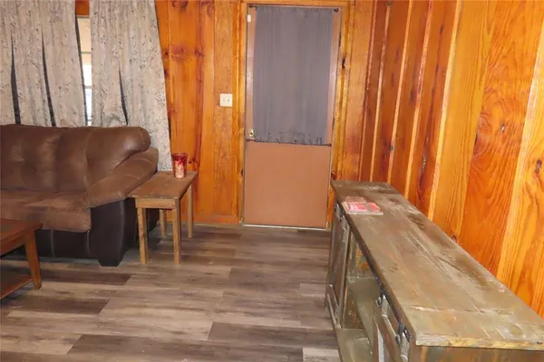a view of a room with windows and furniture