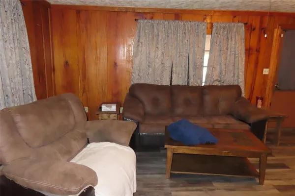 a living room with furniture and a curtain