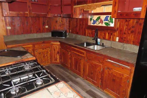 a kitchen with stainless steel appliances granite countertop a sink and a microwave