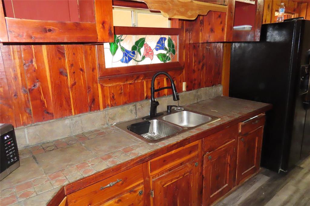 99 Lafayette 215 Road Taylor, AR 71861 - Photo 6 of 18 a kitchen with stainless steel appliances granite countertop a sink and a microwave
