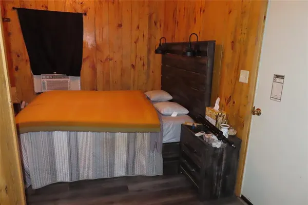 a bedroom with a bed and a chair