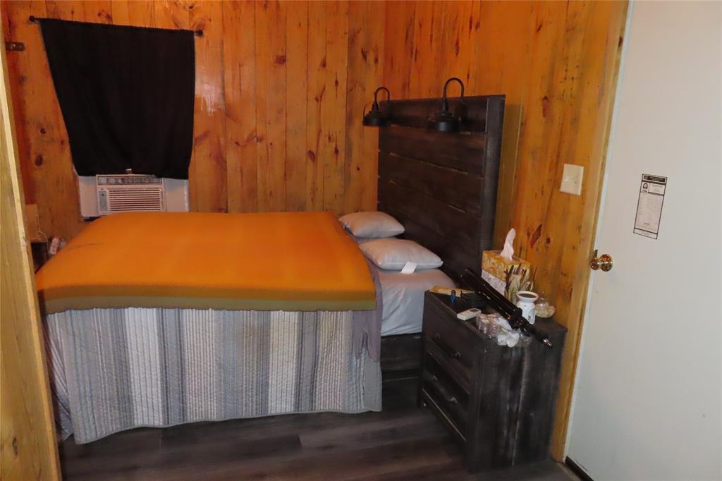 99 Lafayette 215 Road Taylor, AR 71861 - Photo 8 of 18 a bedroom with a bed and a flat tv screen