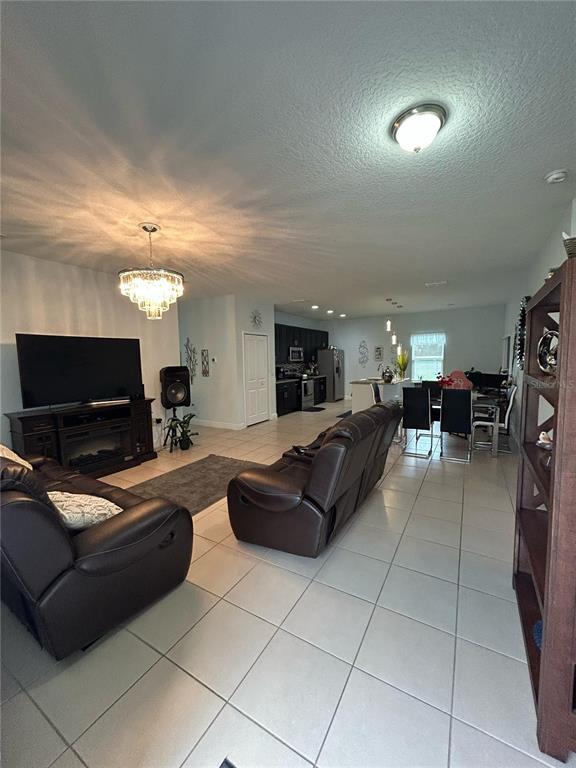810 Cardinal Way Kissimmee, FL 34759 - Photo 3 of 12 a living room with furniture and a flat screen tv
