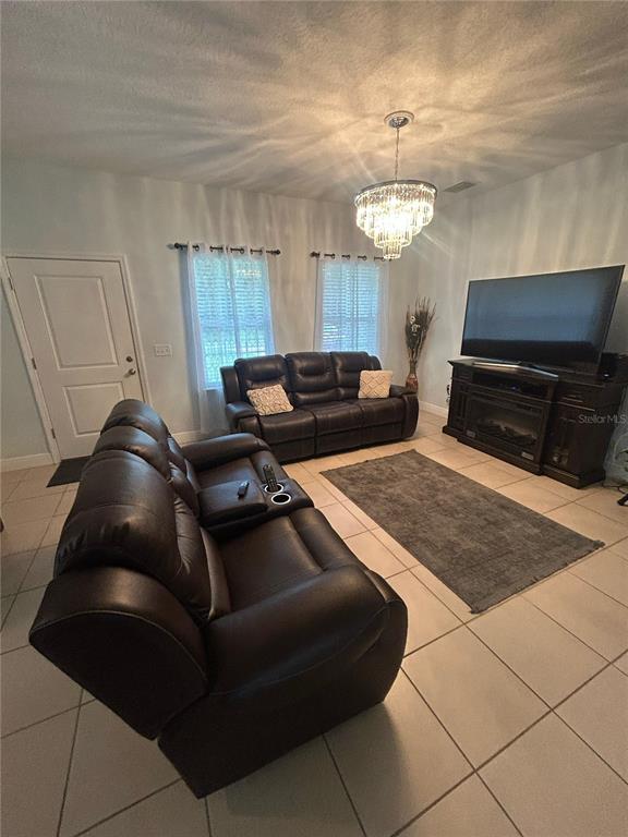 810 Cardinal Way Kissimmee, FL 34759 - Photo 4 of 12 a living room with furniture and a chandelier