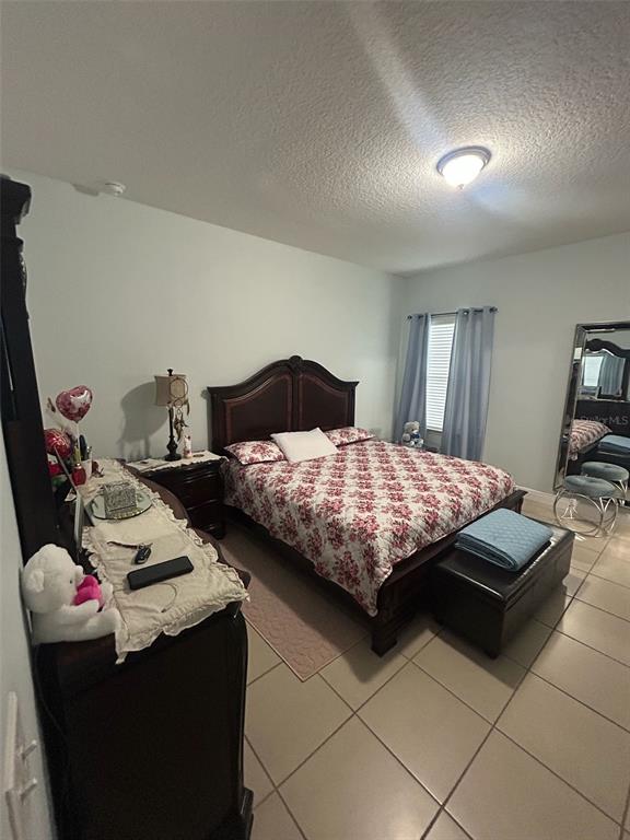 810 Cardinal Way Kissimmee, FL 34759 - Photo 6 of 12 a bedroom with a bed and dresser