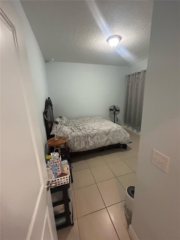 810 Cardinal Way Kissimmee, FL 34759 - Photo 8 of 12 a bedroom with a bed and a dresser in it