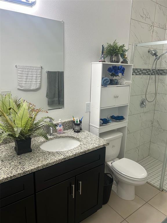 810 Cardinal Way Kissimmee, FL 34759 - Photo 10 of 12 a bathroom with a granite countertop toilet sink and mirror
