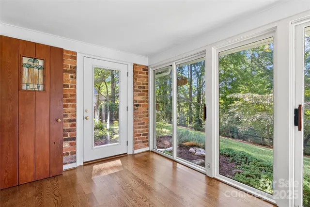 a view of an empty room with wooden floor and wooden floor