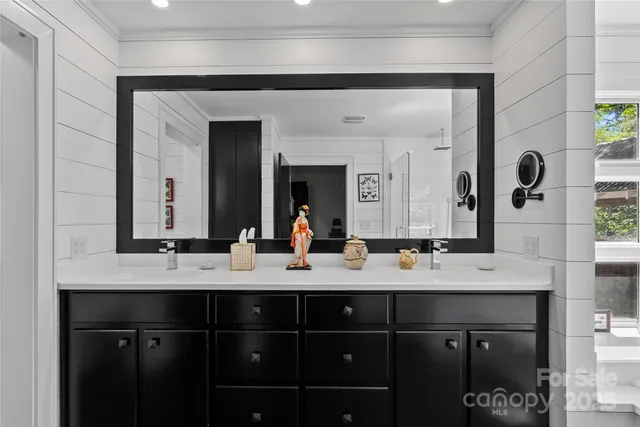 a bathroom with a double vanity sink and mirror