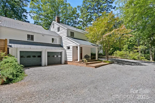a view of a house with a patio and fire pit