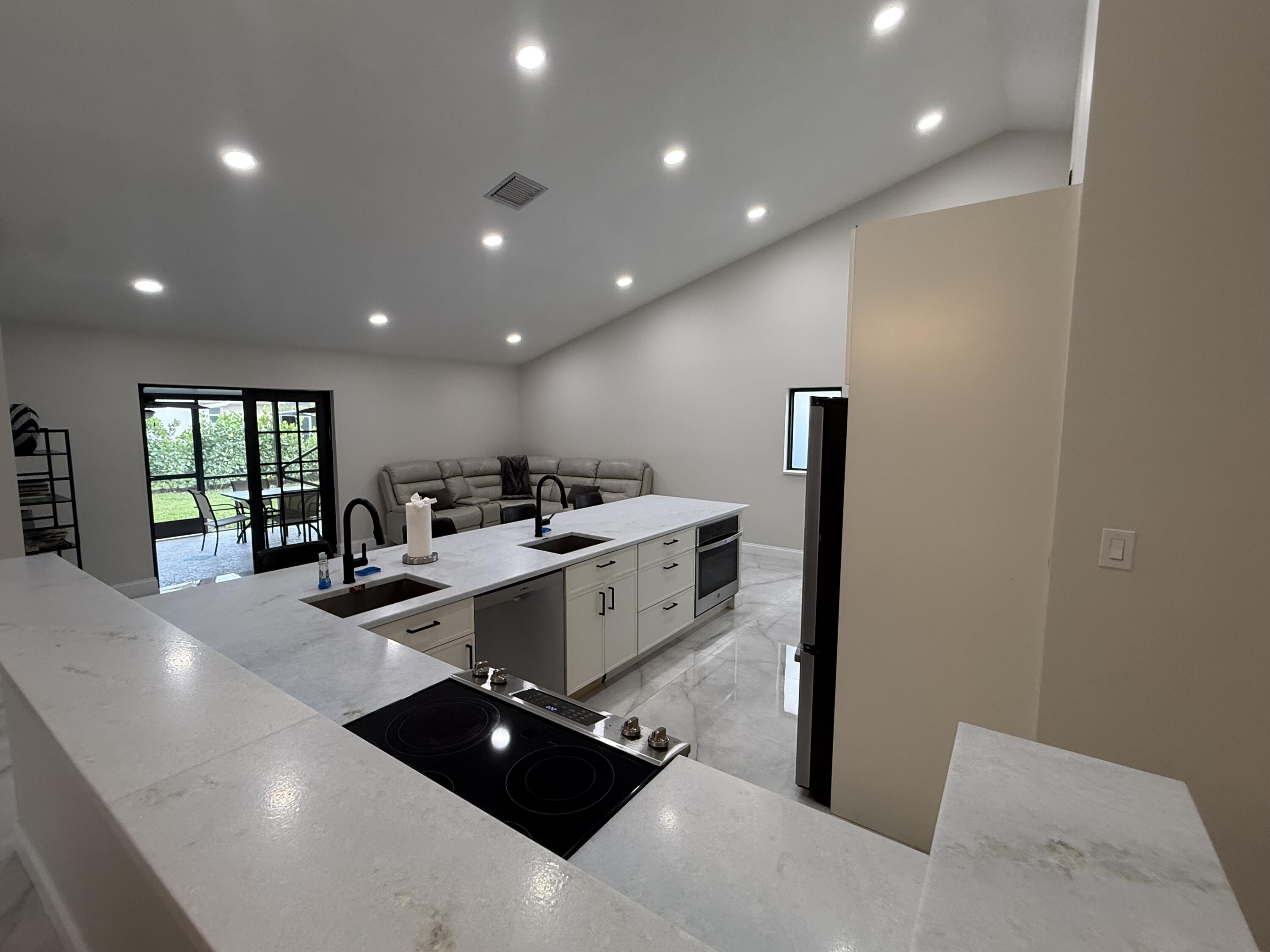 9629 El Clair Ranch Road Boynton Beach, FL 33437 - Photo 4 of 24 the kitchen and family room