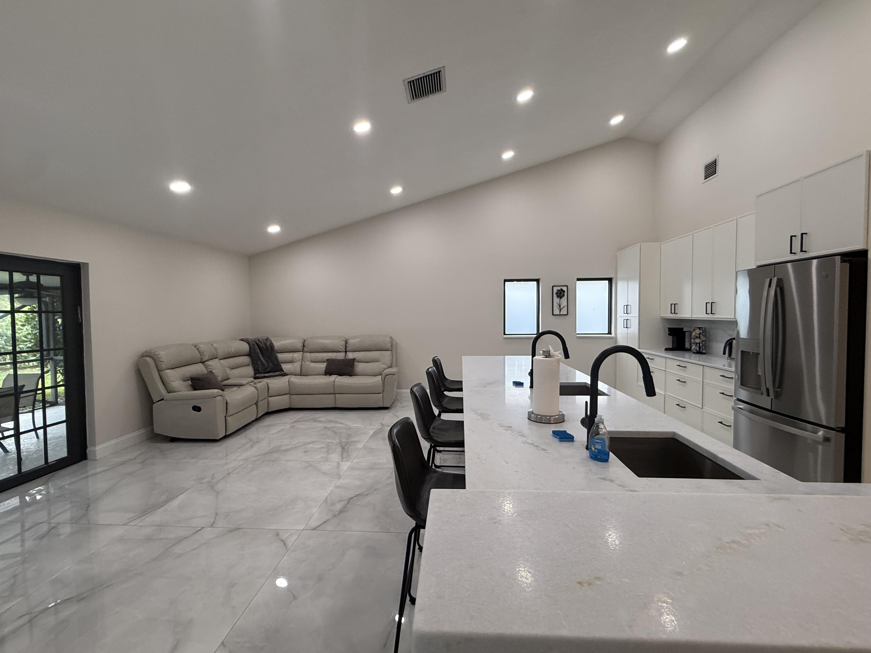 9629 El Clair Ranch Road Boynton Beach, FL 33437 - Photo 7 of 24 the kitchen and family room 2