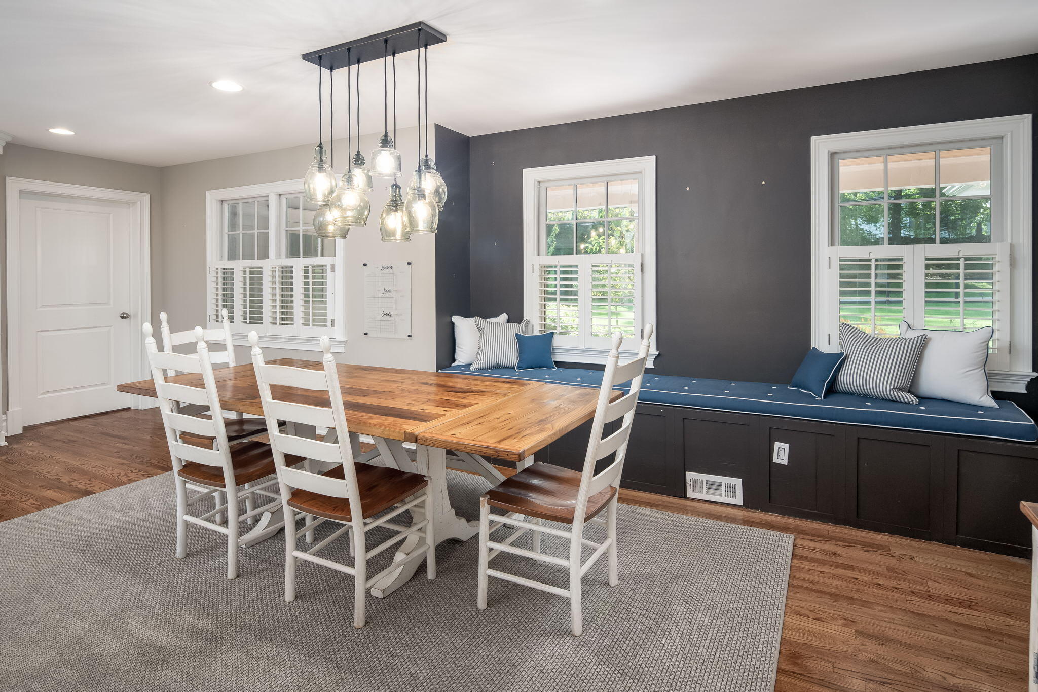 82 Pipers Hill Road Wilton, CT 06897 - Photo 14 of 35 a dining room with a wooden table and chairs