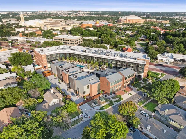 an aerial view of a house with a big yard