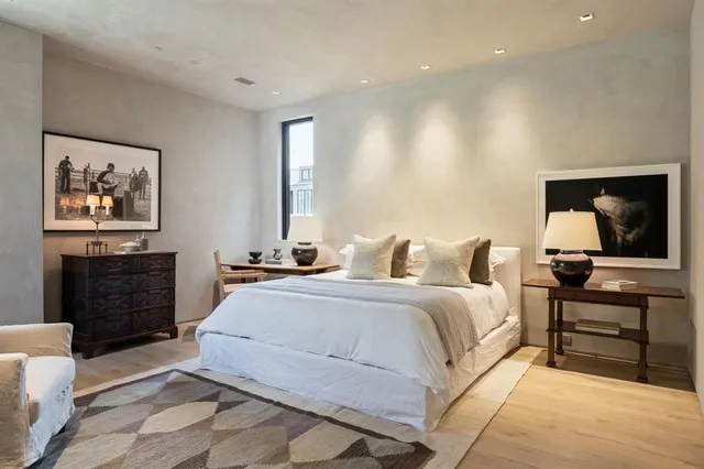 a spacious bedroom with a bed and furniture