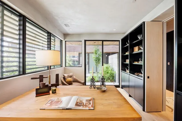 a living room with couch guitar and flat screen tv