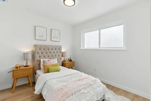 a bedroom with a large bed and a large window