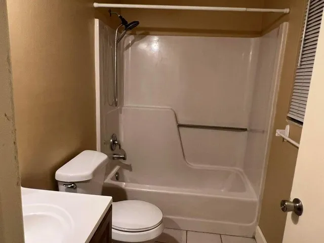 a bathroom with a toilet and shower