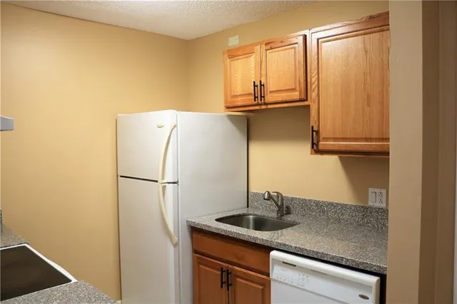 a kitchen with a sink and a refrigerator