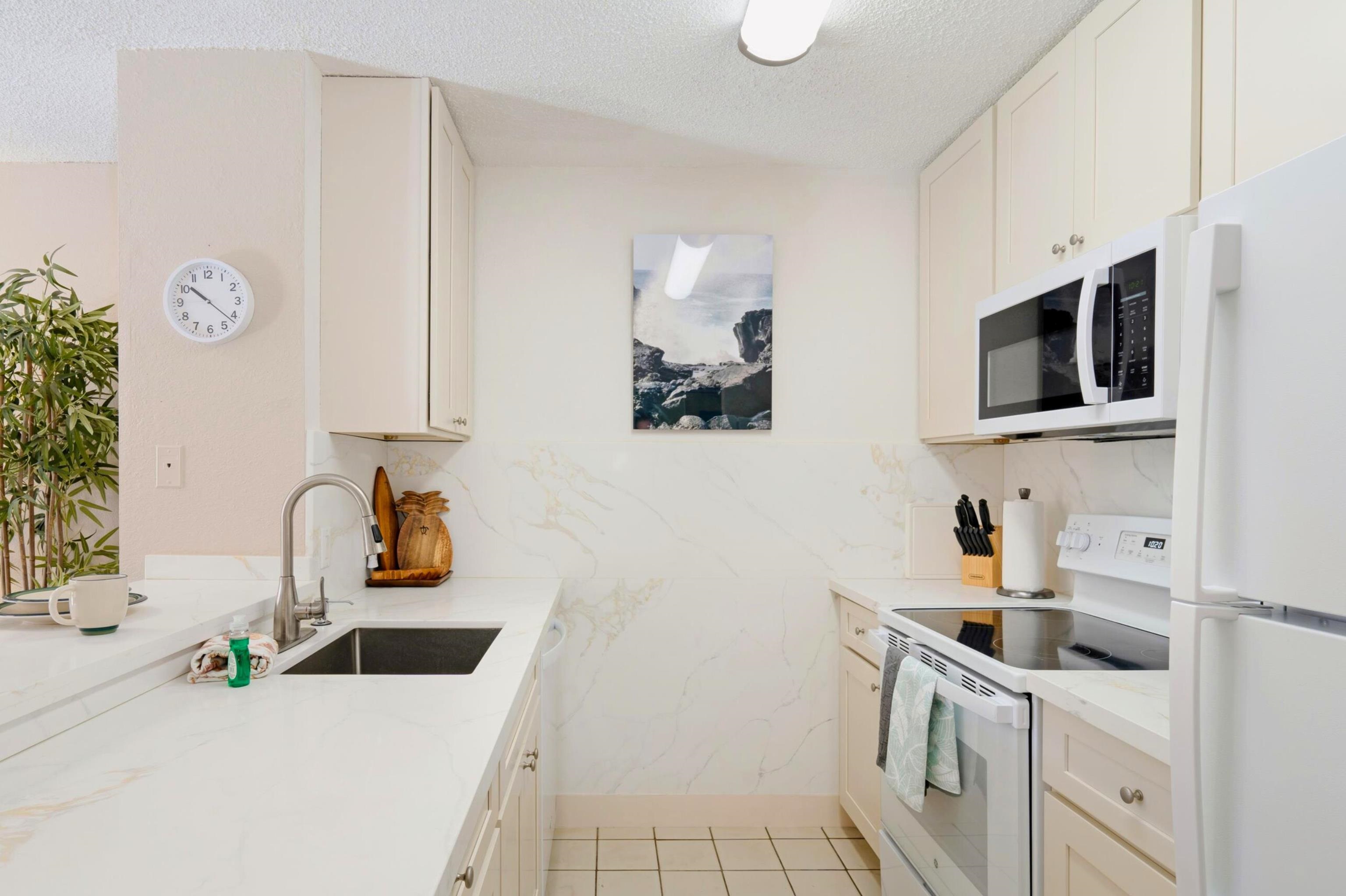 1299 Uluniu Road, Unit G104 Kihei, HI 96753 - Photo 7 of 32 a kitchen with a sink dishwasher stove and cabinets