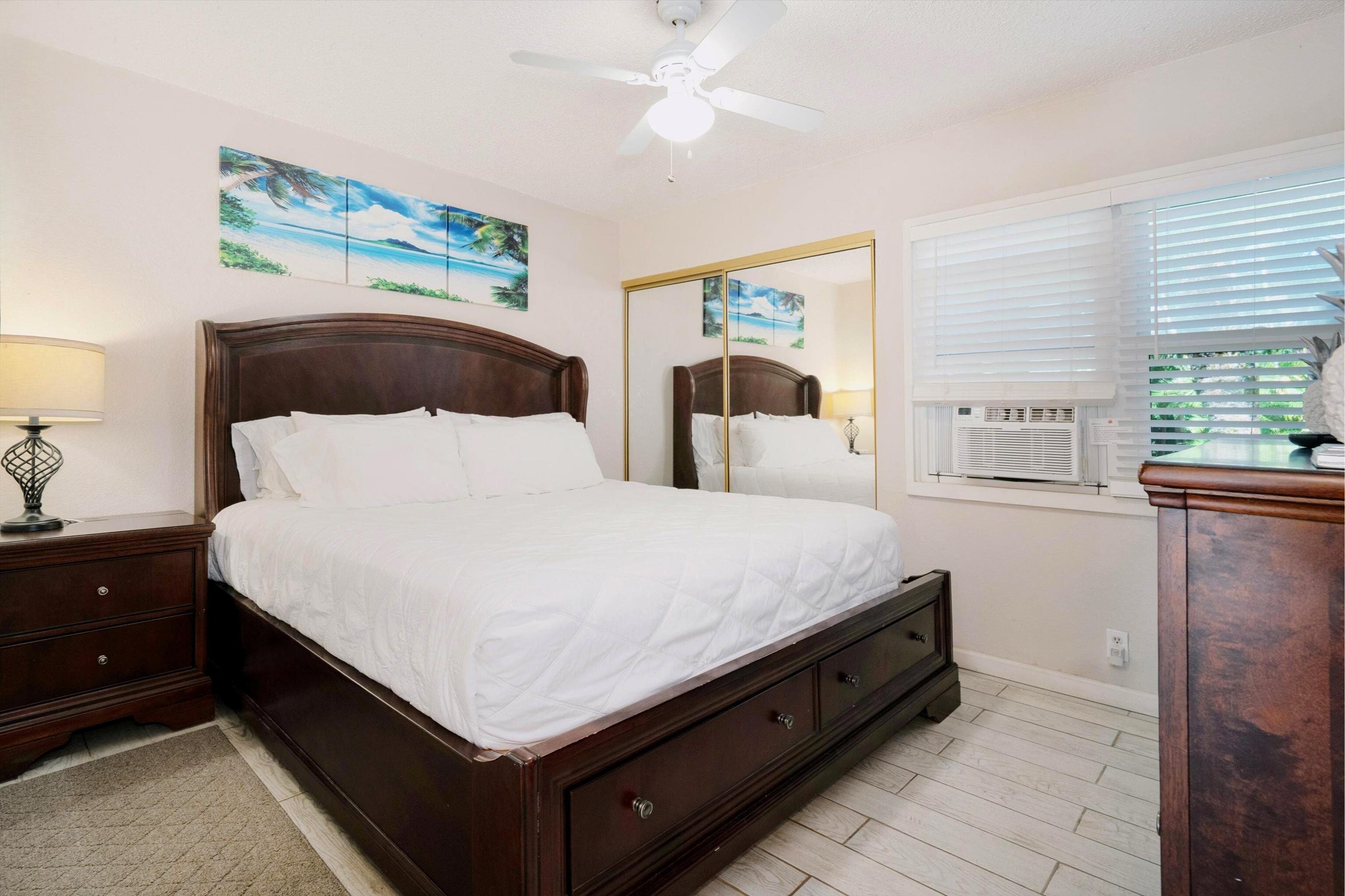 1299 Uluniu Road, Unit G104 Kihei, HI 96753 - Photo 8 of 32 a large bed sitting in a bedroom next to a window