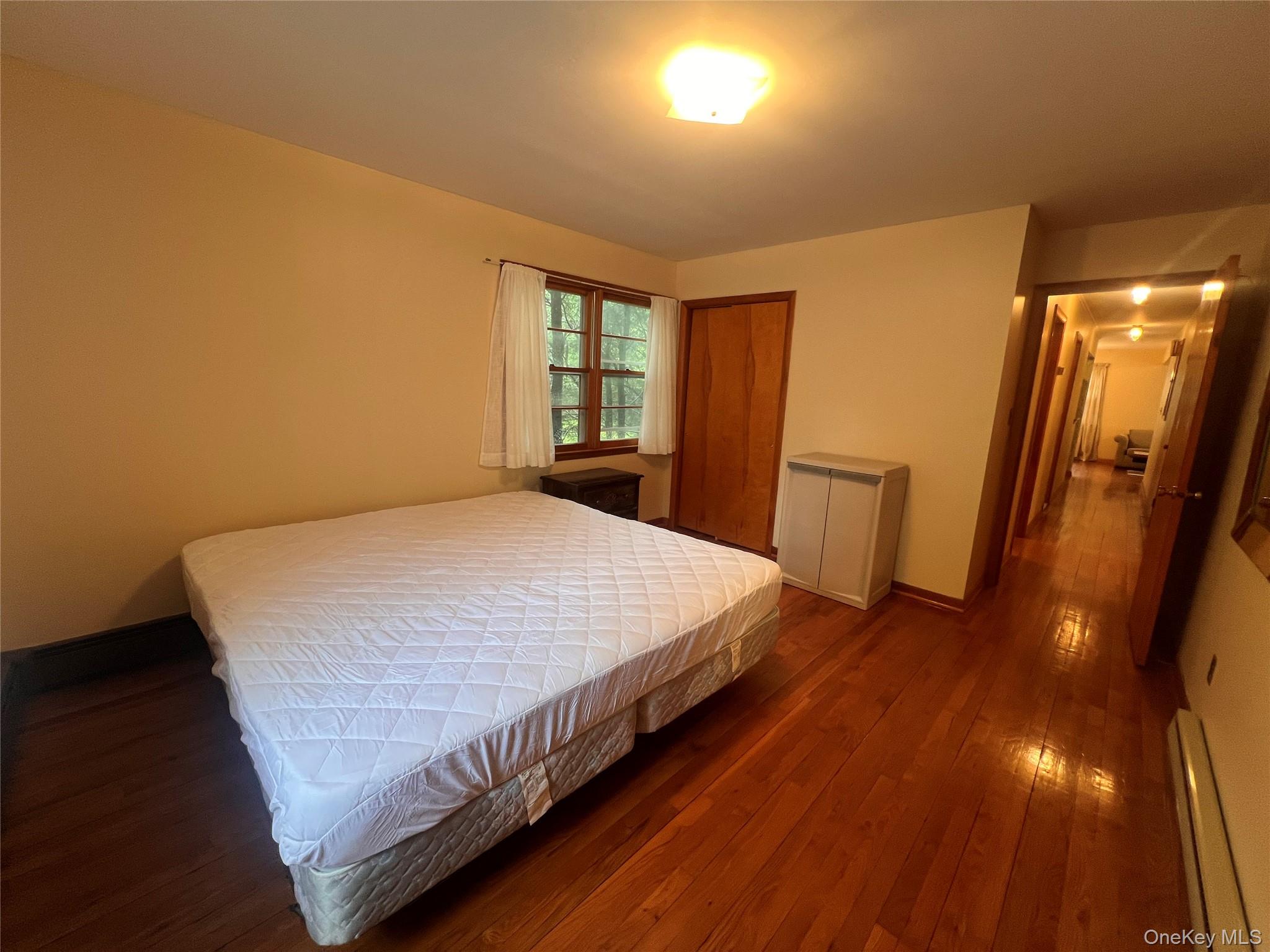 4 Beach Road, Unit G Glen Spey, NY 12737 - Photo 12 of 16 a bed sitting in a room next to a window