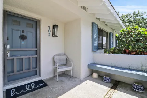 a outdoor space with a couch and a potted plant