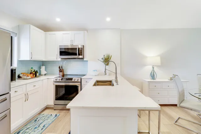 a kitchen with a stove a sink and a microwave
