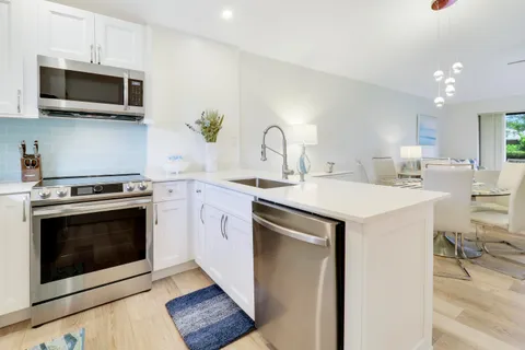 a kitchen with a stove microwave and sink