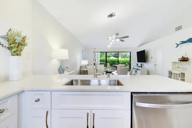 a kitchen with a sink a counter top space and a window