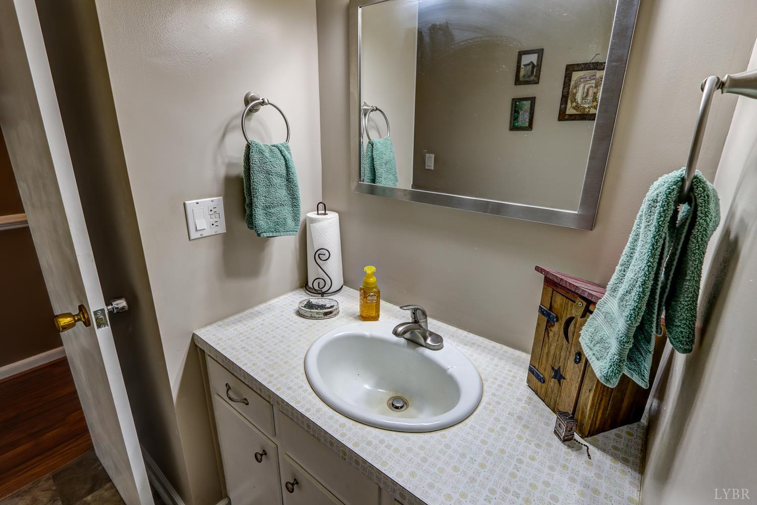 7143 Gladys Road Altavista, VA 24517 - Photo 22 of 48 a bathroom with a sink and mirror