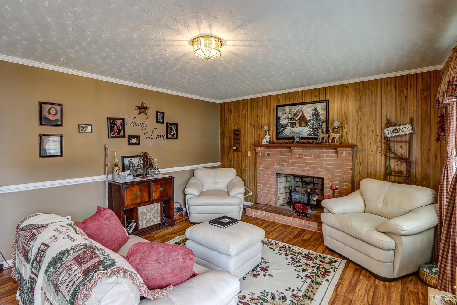 7143 Gladys Road Altavista, VA 24517 - Photo 10 of 48 a living room with furniture fireplace and a flat screen tv