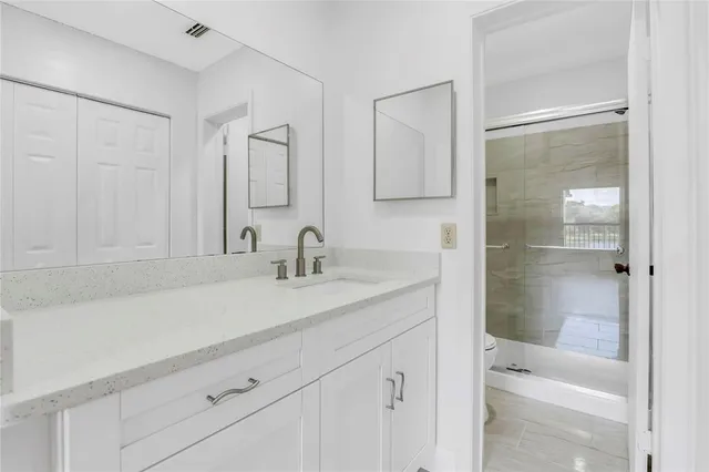 a bathroom with a sink and a mirror with bathtub