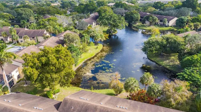 an aerial view of a house with a yard and lake view