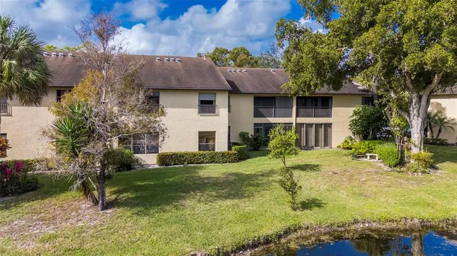 a view of house with a yard