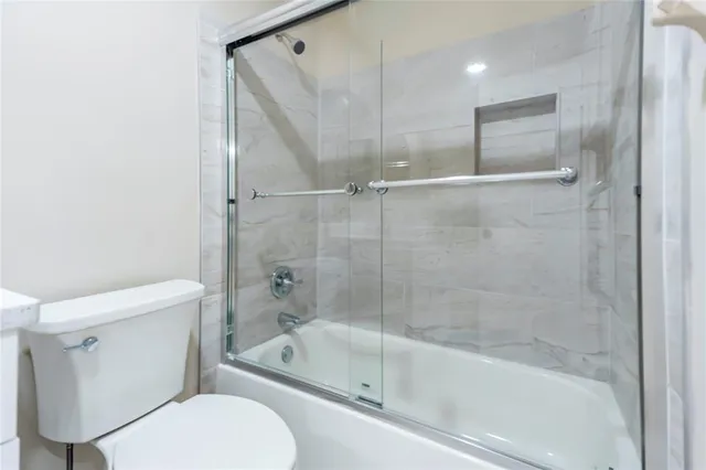 a bathroom with a glass shower door