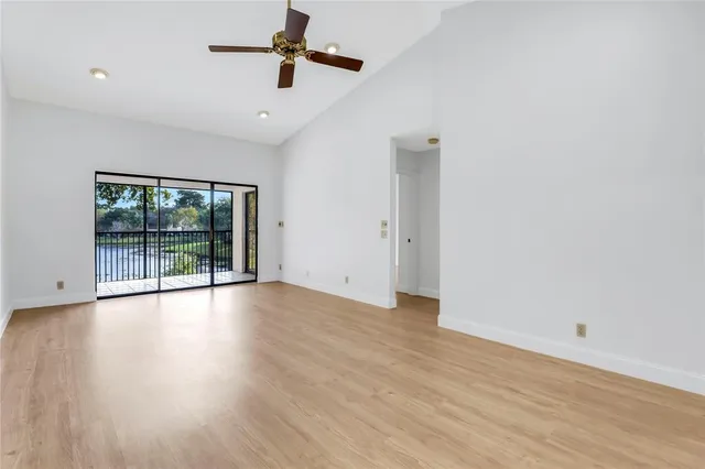 a view of room with wooden floor and fan