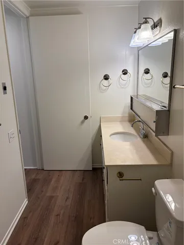 a bathroom with a sink toilet and mirror