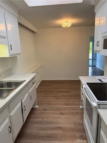 a kitchen with stainless steel appliances granite countertop a sink and a stove