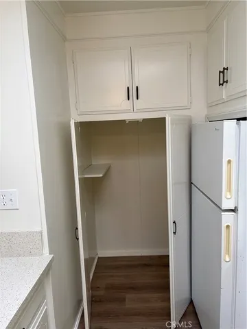 a view of walk in closet with empty racks
