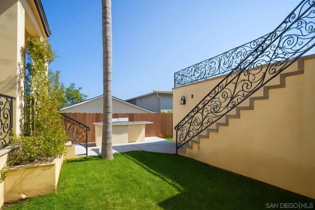 a view of a house with a yard and deck