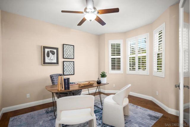 a bedroom with a bed ceiling fan and a window