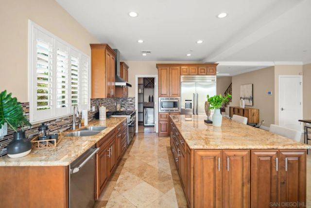 a kitchen with sink a counter top space and living room