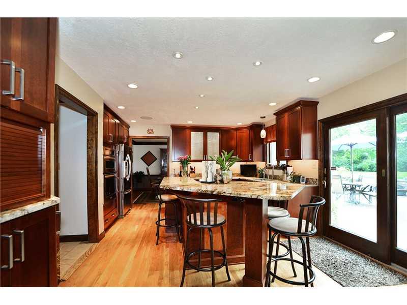 415 Pinkerton Road Wexford, PA 15090 - Photo 3 of 21 Kitchen. Wow! Newer ceiling height cherry cabinets, some with glass inserts, soft close doors & drawers, under cabinet lighting, accent & recessed lighting, granite counters, pantry, refinished hardwood floors. 2 tier island with seating!
