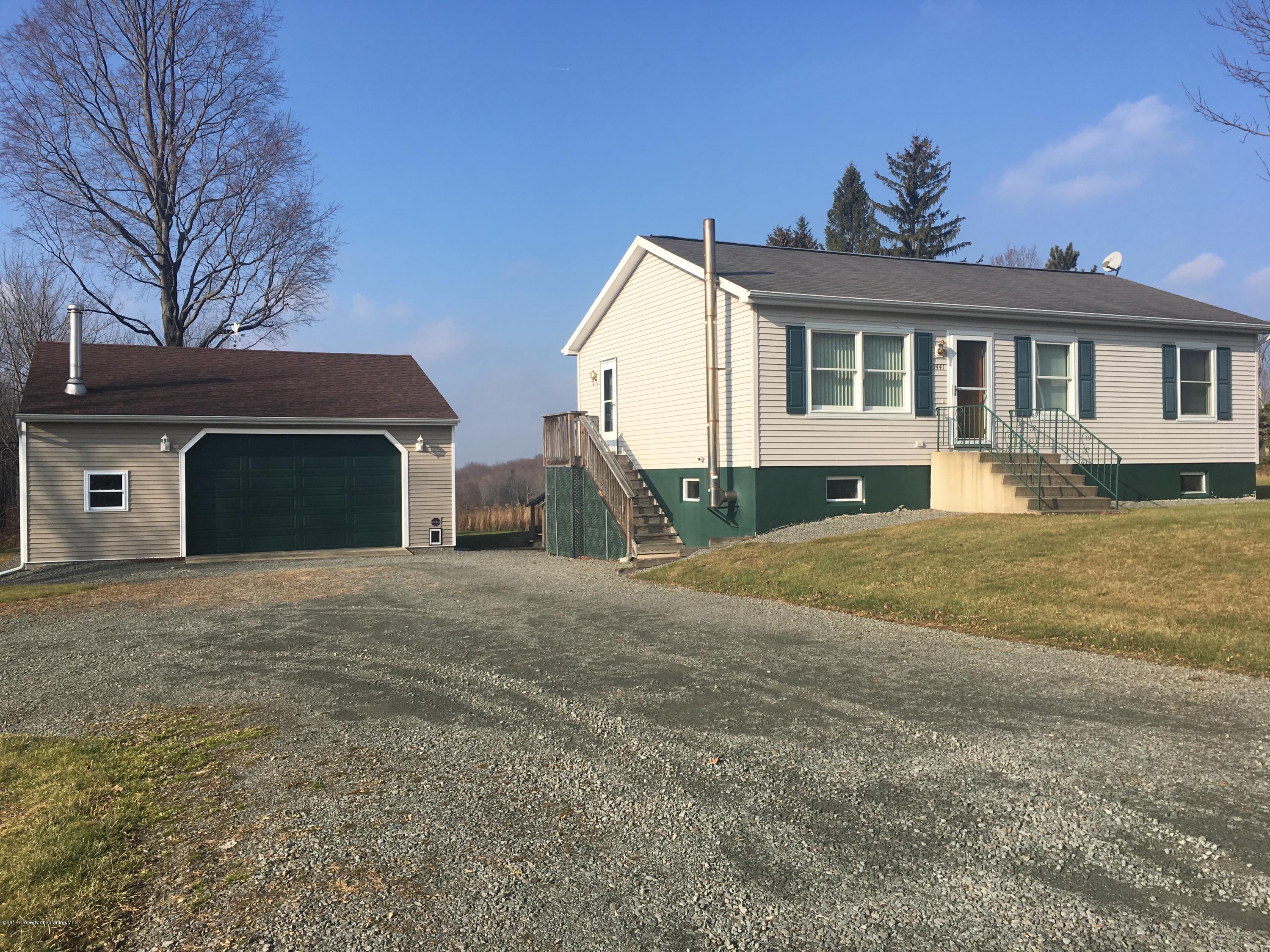 5441 Cottrell Road Union Dale, PA 18470 - Photo 1 of 19 a front view of a house with a yard and garage
