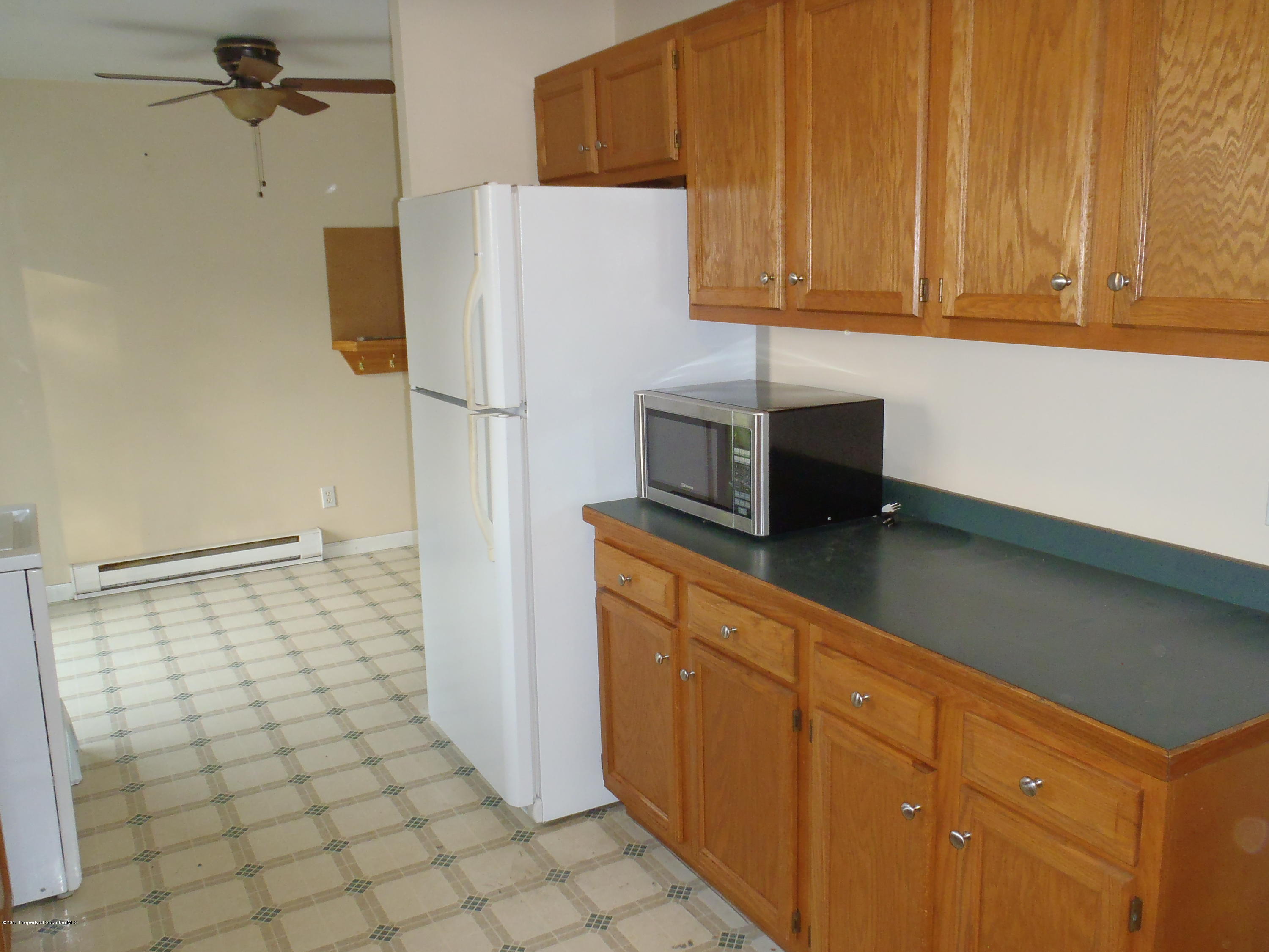5441 Cottrell Road Union Dale, PA 18470 - Photo 11 of 19 a kitchen with a refrigerator and cabinets
