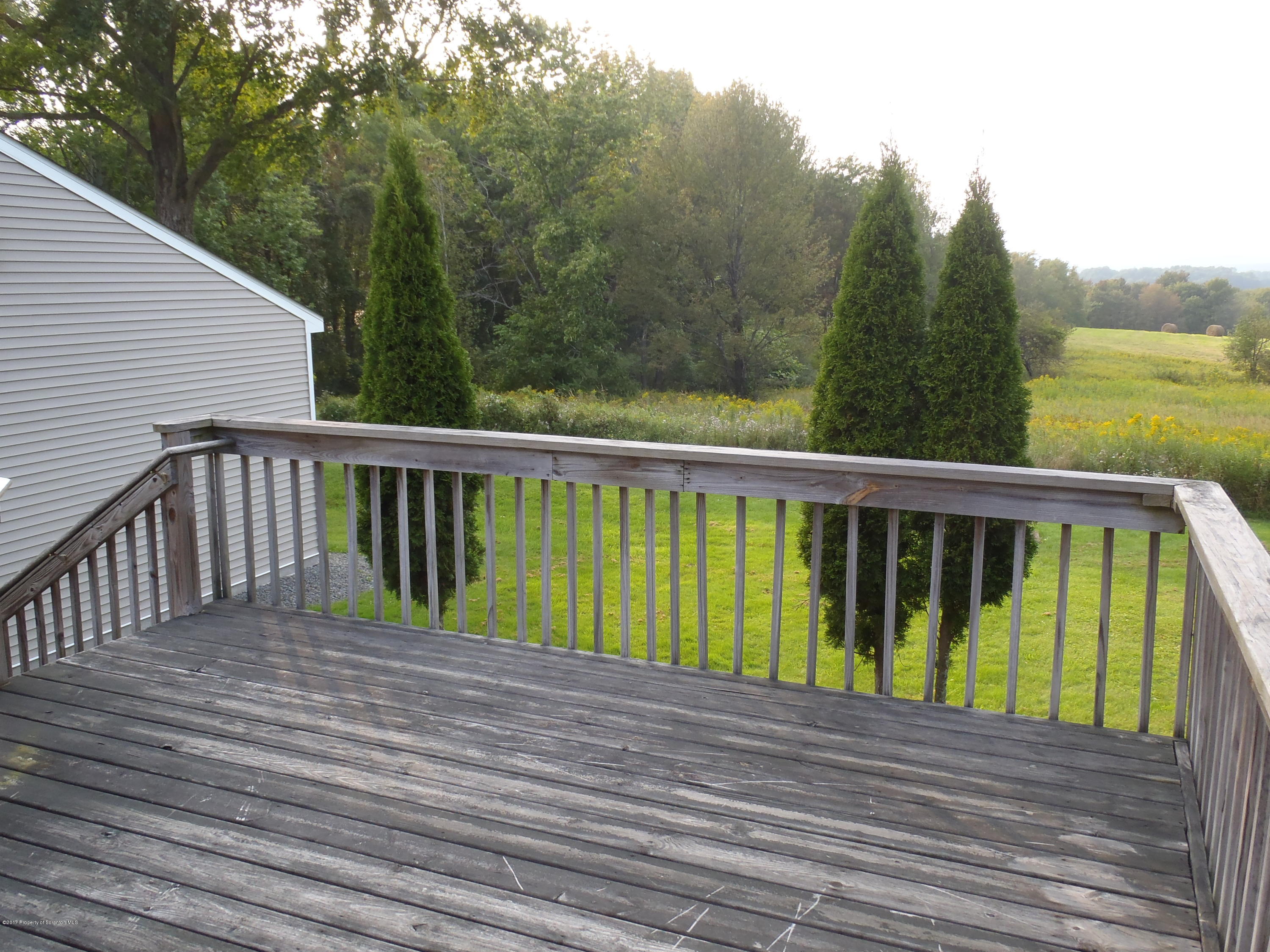 5441 Cottrell Road Union Dale, PA 18470 - Photo 2 of 19 a view of balcony with wooden floor and fence