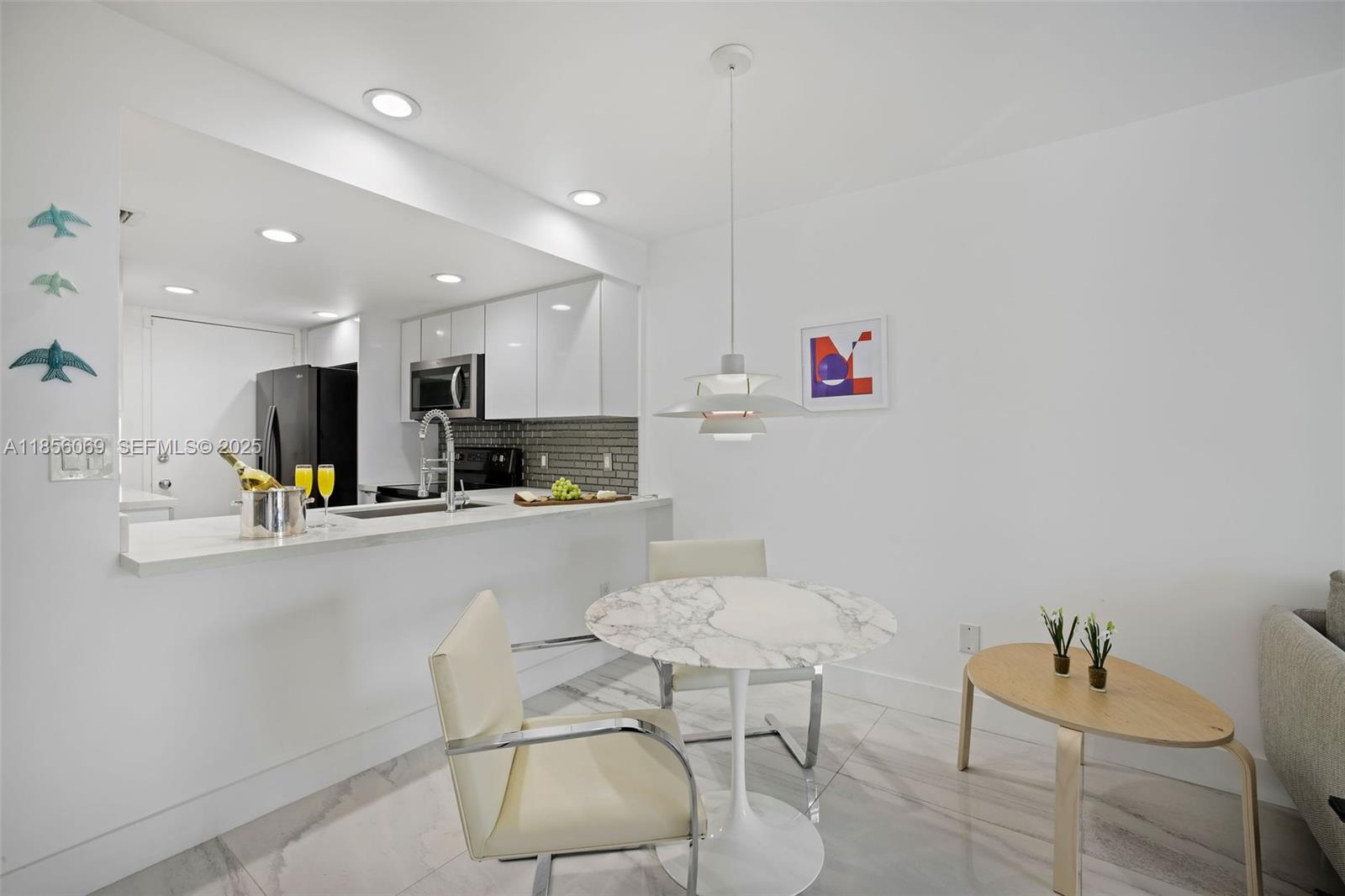 1450 Lincoln Road, Unit 403 Miami Beach, FL 33139 - Photo 14 of 29 a kitchen with a dining table chairs and view living room